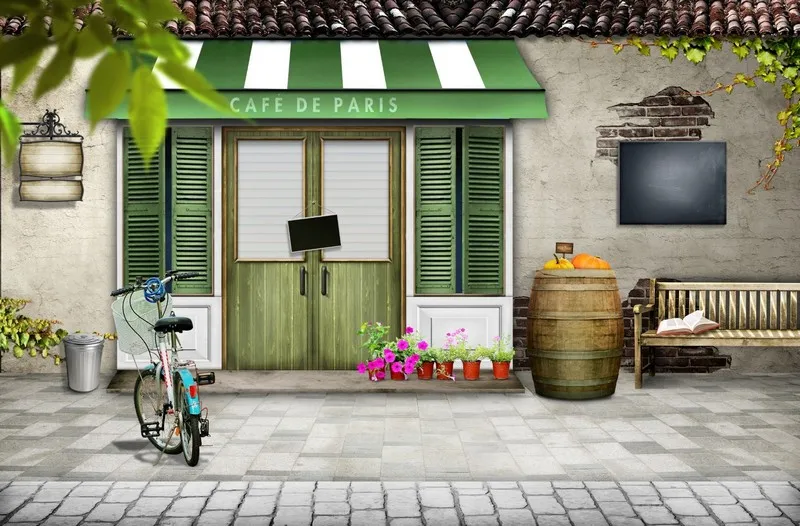 "Cafe de Paris" yazılı yeşil tenteli kafe girişi ve vintage bisiklet illüstrasyonlu duvar kağıdı.